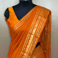 Timeless Light Orange Crepe Saree with Stunning Zari Detailing
